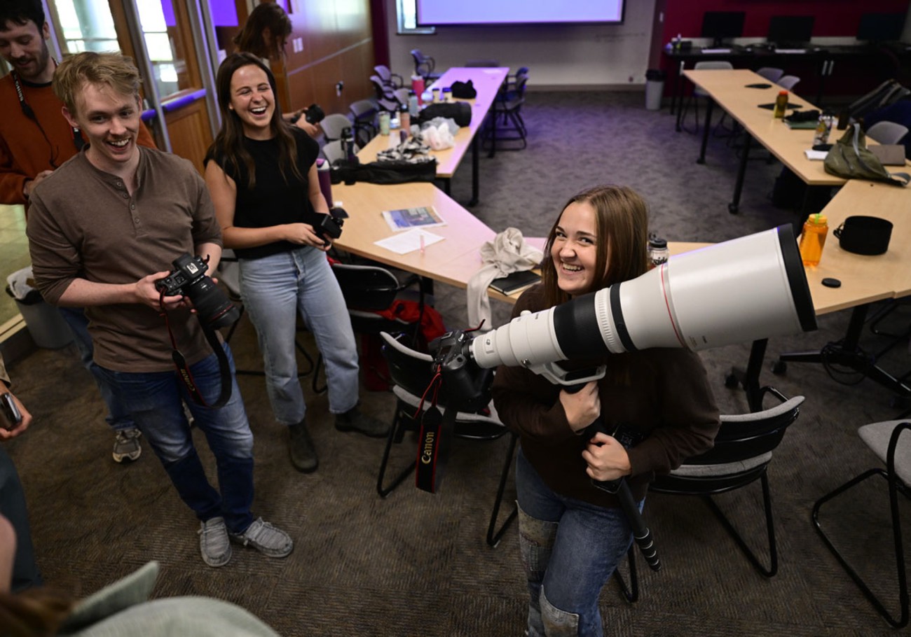 Students with long camera lenses at the Montana Photo Workshop